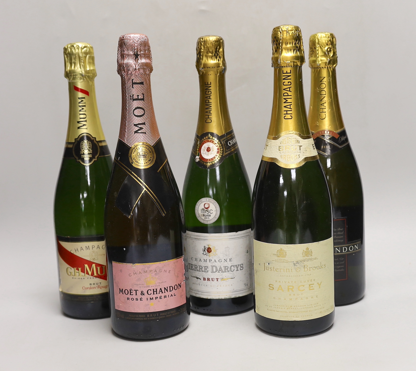 Five bottles of various champagnes: Pierre Darcys, G.H. Mumm, Chandon, Moët & Chandon and Justerini & Brooks Sarcey